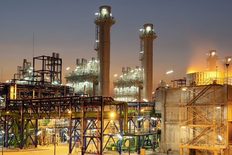 Concept Pollution and industrialization . Details of oil pipelines with valves in large oil refineries, in sunrise time refining equipment, close-up of industrial pipelines of oil refineries.