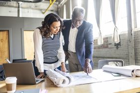 Two teammates discussing strategies and insurance options for their small business.