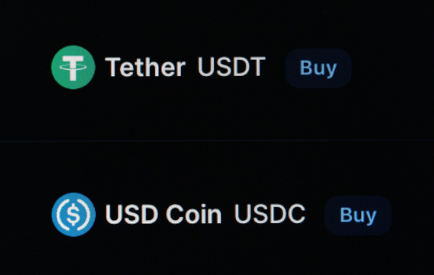 Logos of stablecoins Tether (USDT) and USD Coin (USDC) on a computer screen