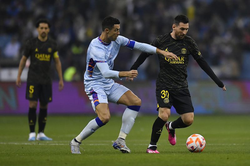 Leo Messi of Paris Saint-Germain and Cristiano Ronaldo of Ruyadh XI fight for possession during the friendly match between Paris Saint-Germain and Riyadh XI at King Fahd International Stadium on January 19, 2023 in Riyadh, Saudi Arabia.