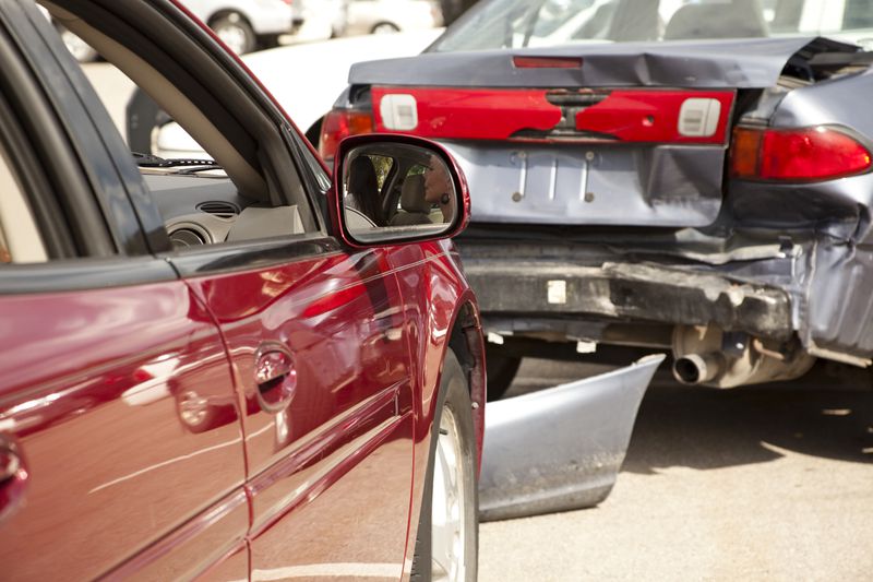 Two-car accident, wreck with people still inside one vehicle.