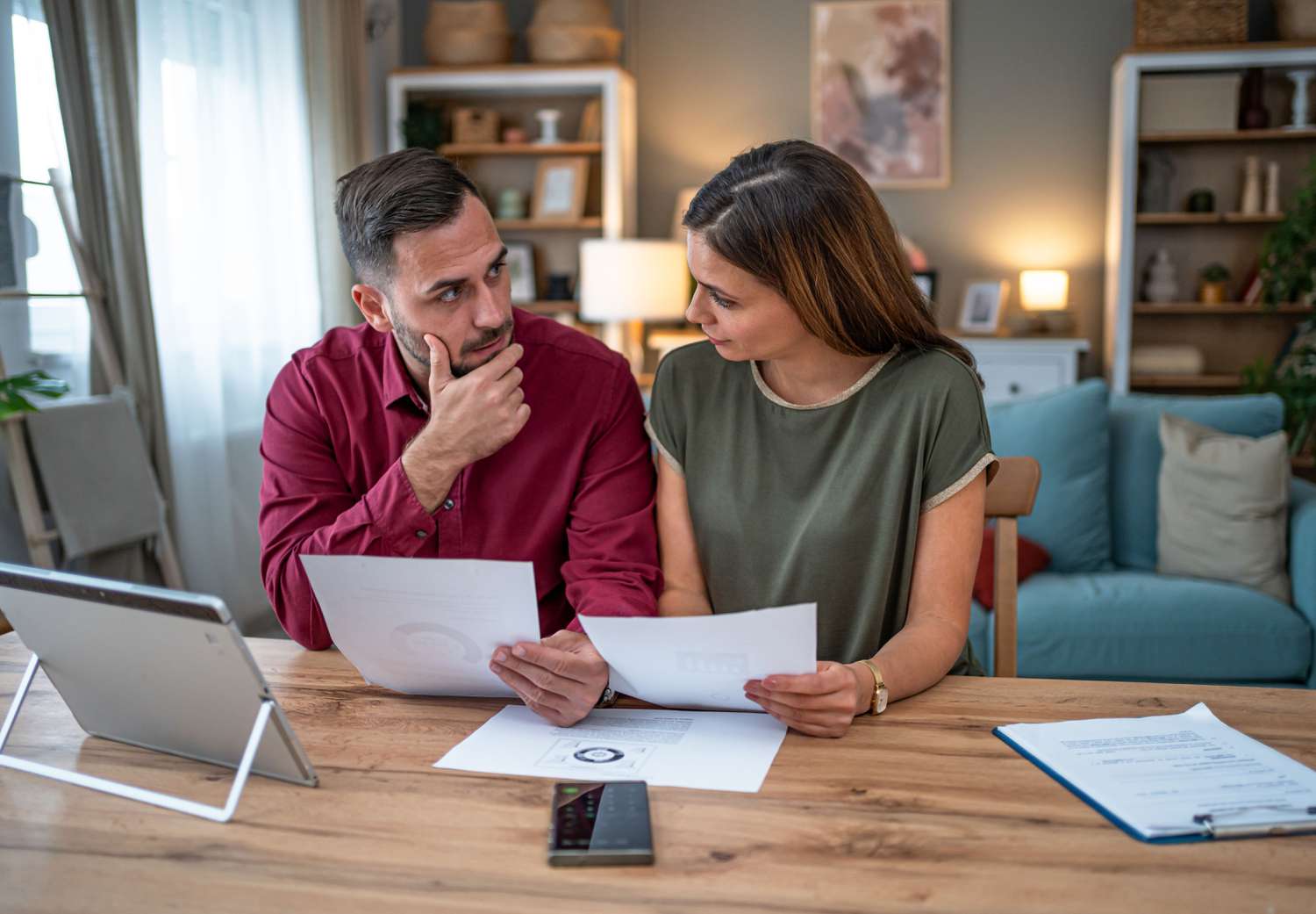 Two people looking at paperwork at home