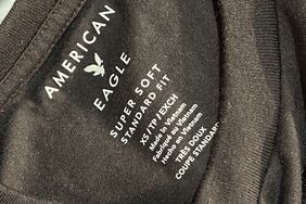 The inside of a black shirt says "American Eagle, Super Soft Standard Fit" with other size and manufacturing information.