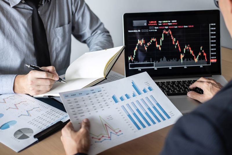 Investors review asset allocation charts and stock charts