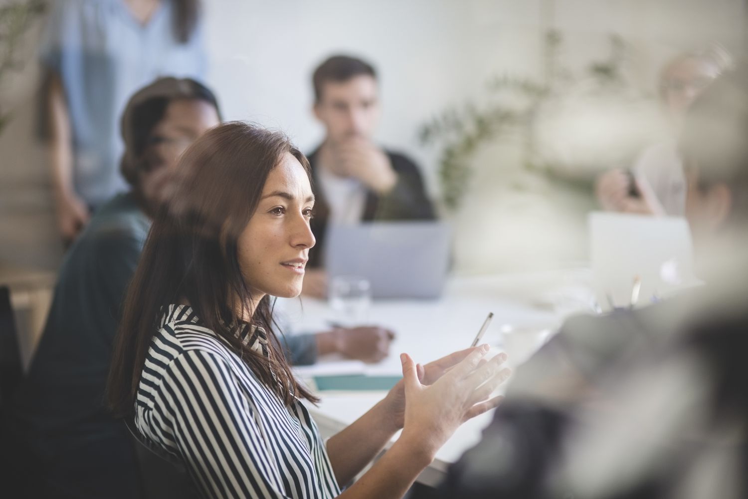 Woman explaining colleagues during brainstorming session in an office