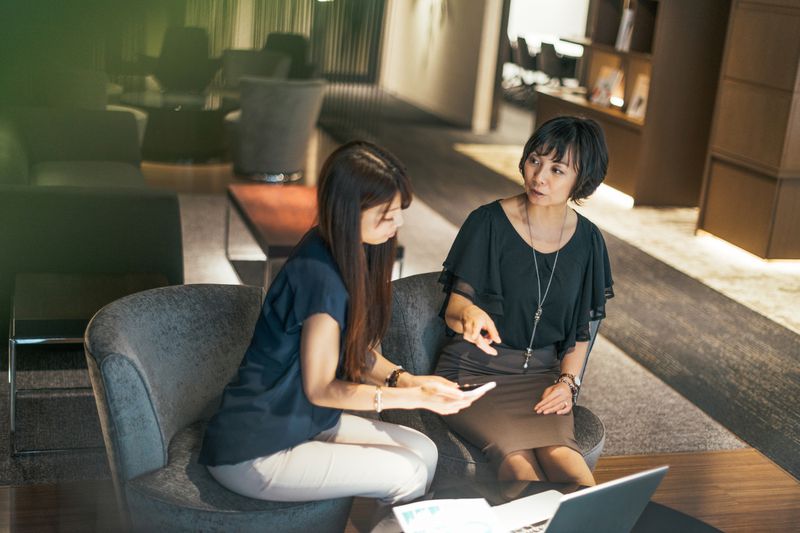 A woman seeks advice from young expert in the field of insurance an investments.