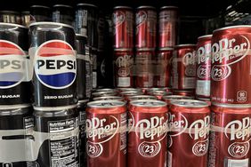 Cans of Zero Sugar Pepsi and Dr. Pepper are seen on a shelf.