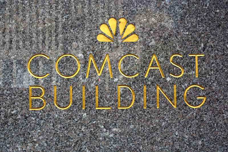 Logo embellishes a granite wall near the entrance to the Comcast Building in New York.