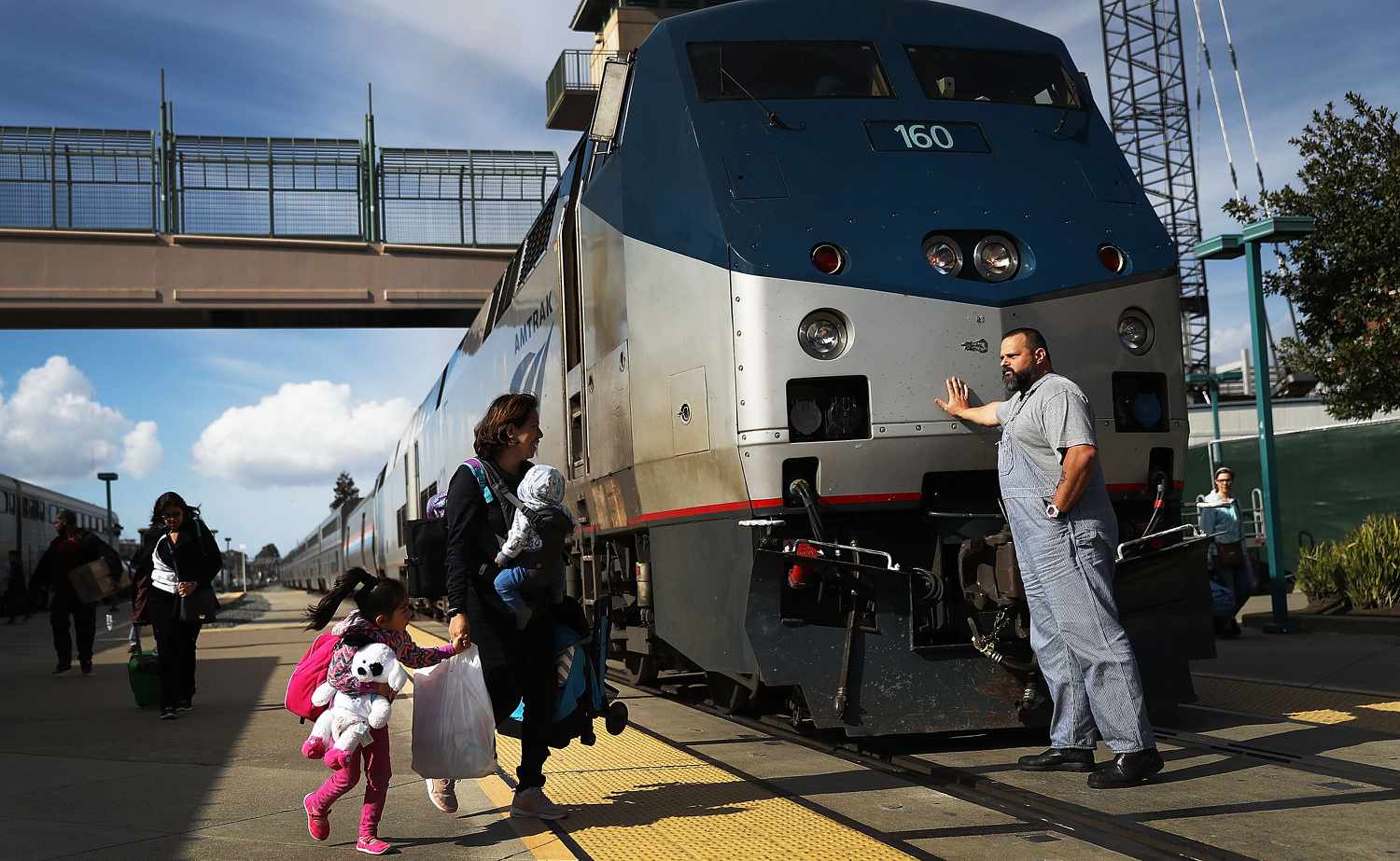 An Amtrak engineer leans on the locomotive as passengers disembark from Amtrak's California Zephyr at the end of its daily 2,438-mile trip to Emeryville/San Francisco from Chicago that took roughly 52 hours on March 25, 2017 in Emeryville, California.