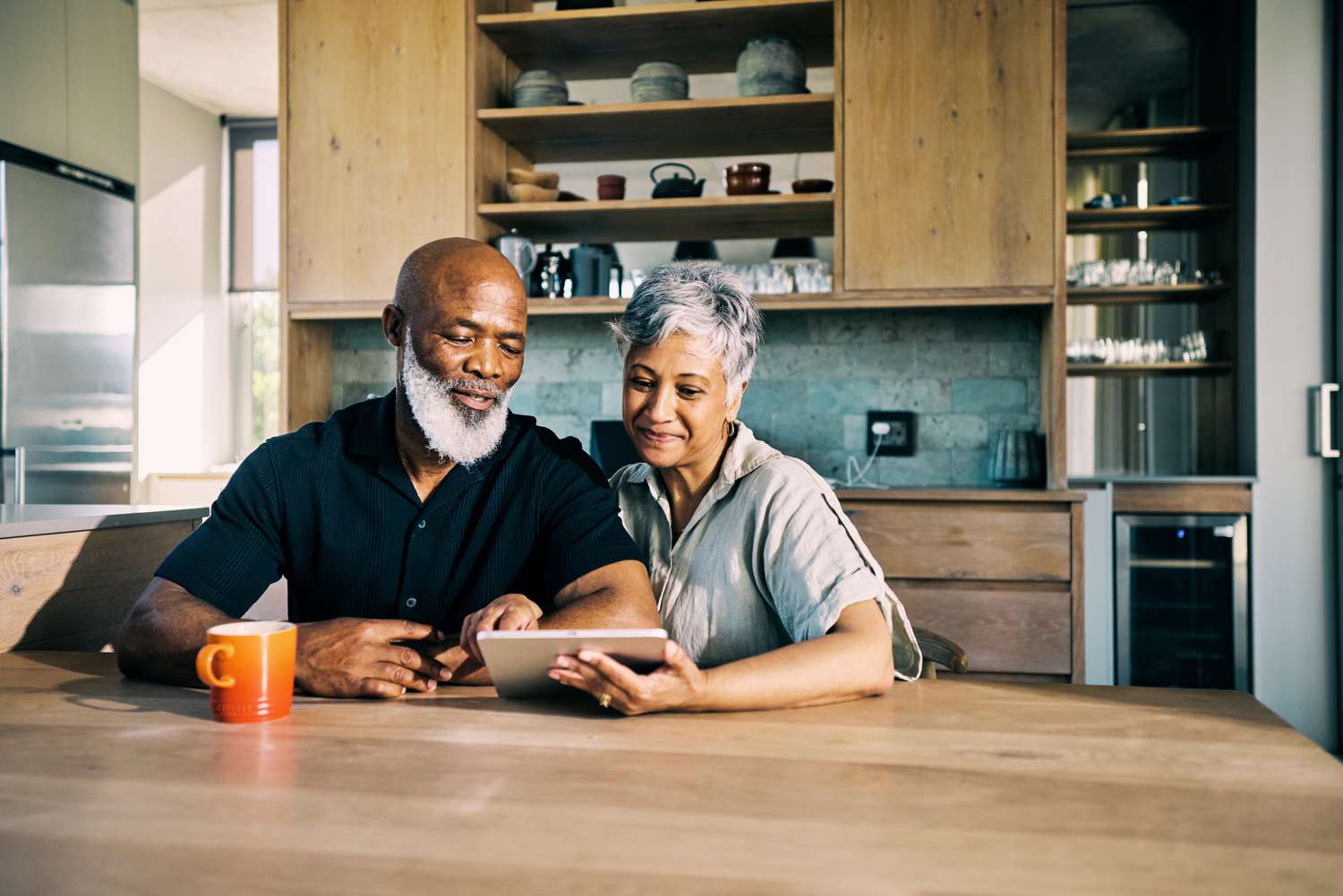 Couple at a table looking at a tablet