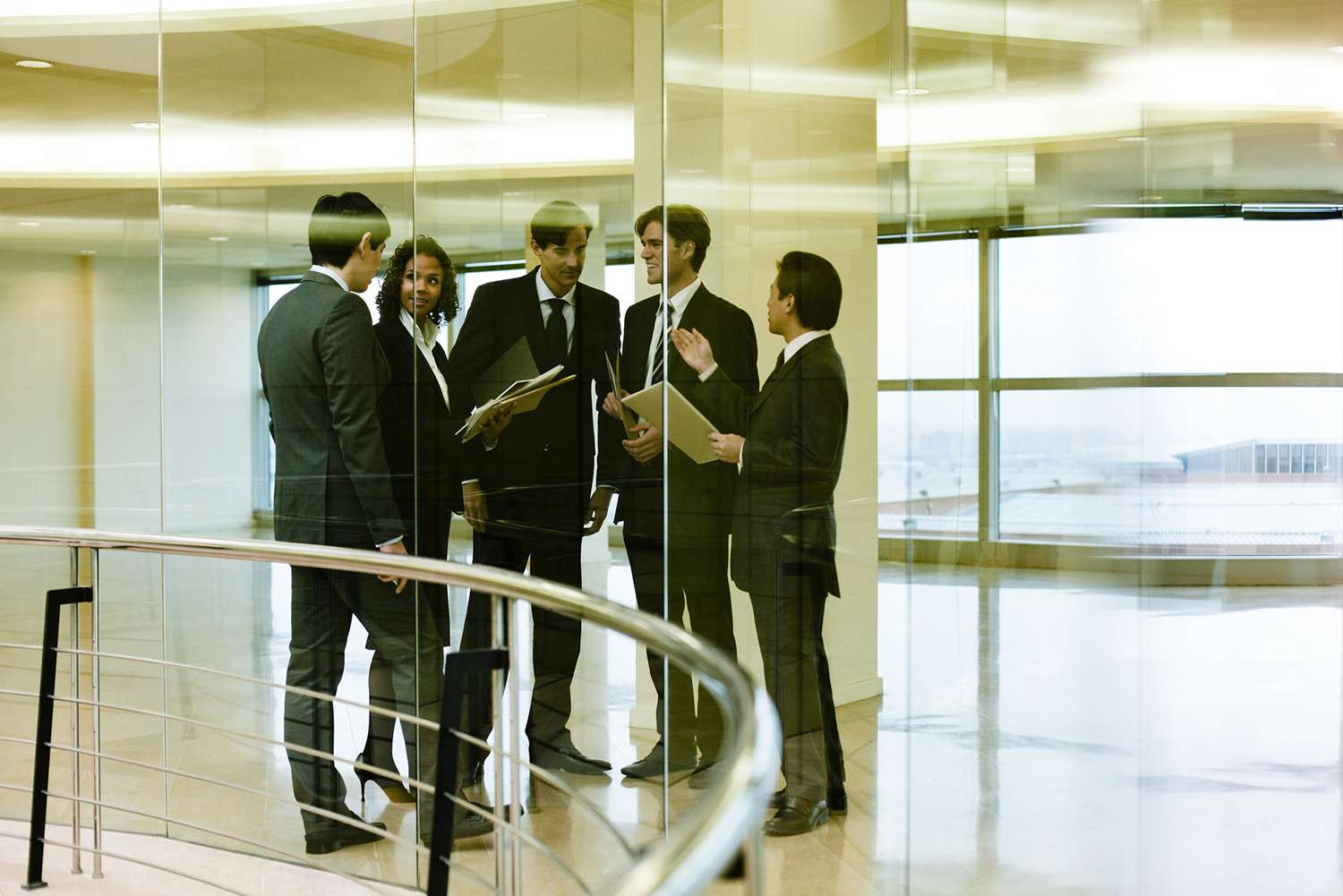 Team of Executives Meeting in Corridor