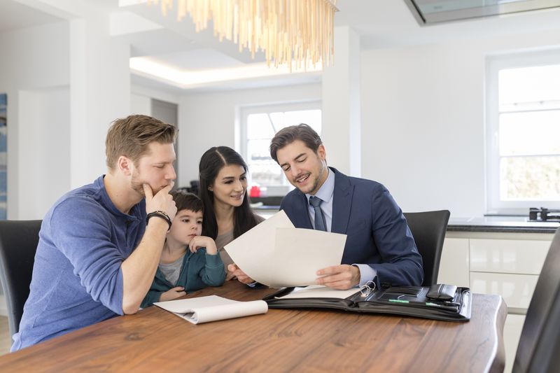 A family talking with an accountant sitting at the table.