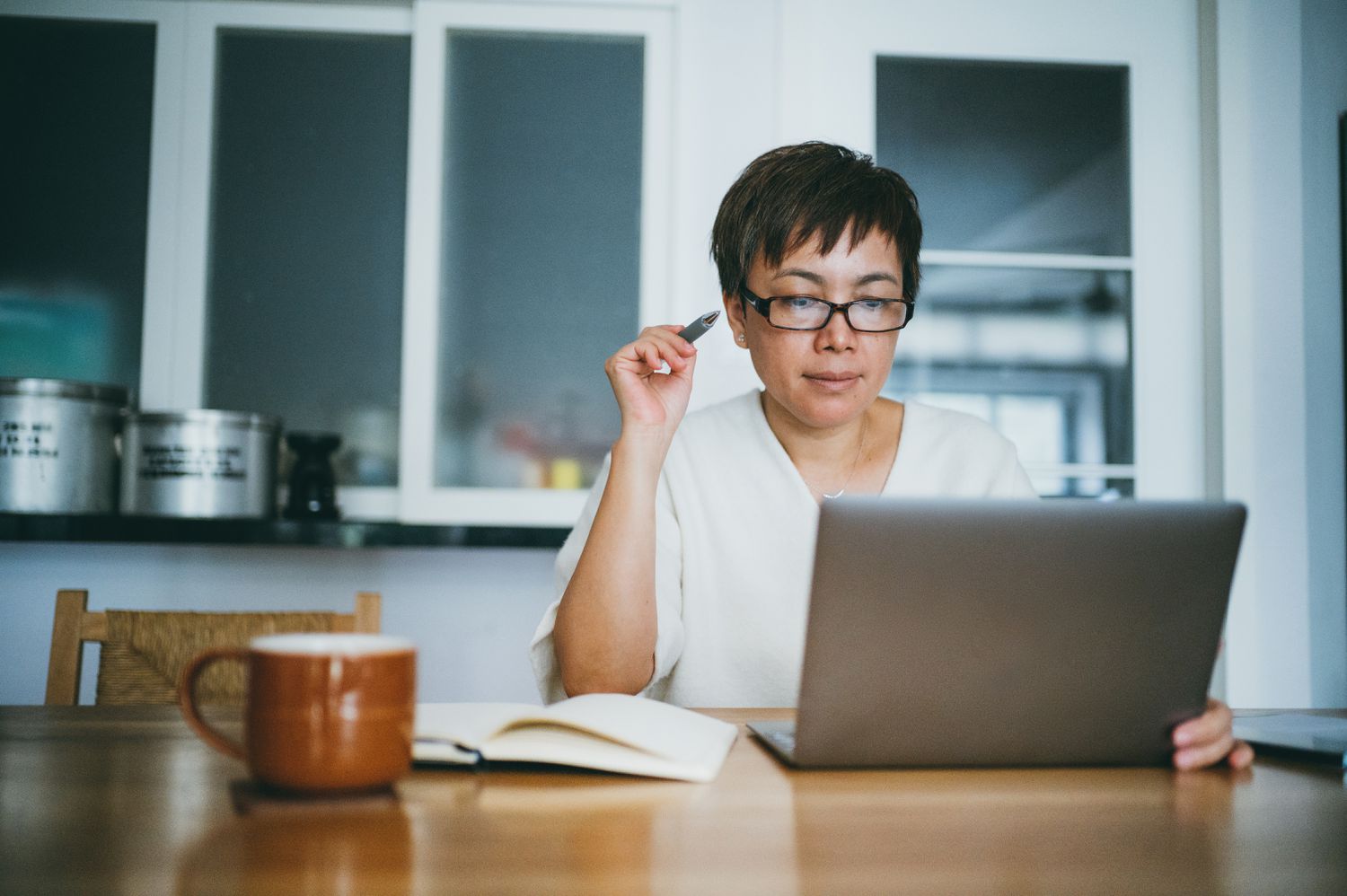Person sitting at table using a laptop computer working on a tax return