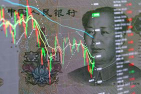 Yuan banknote on background of stock charts