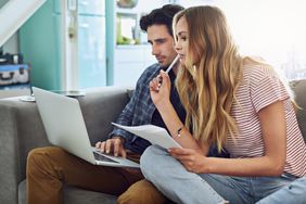 Couple reading refinance loan rates for May 30, 2025