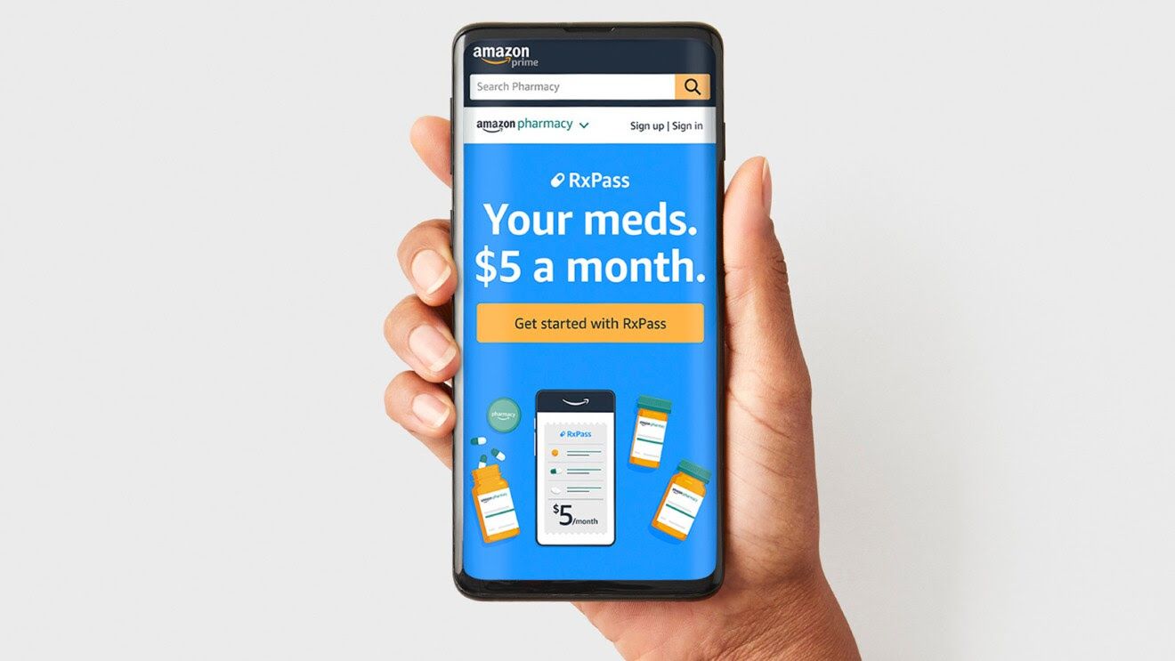 Hand holding a smartphone displaying Amazon's RxPass medication delivery