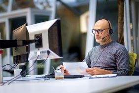 Person working on computers at a desk