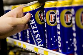 Fosters lager being pulled off of a shelf.