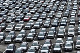 : In an aerial view, brand new Subaru cars sit in a storage lot at Auto Warehouse Co. on March 04, 2025 in Richmond, California. 