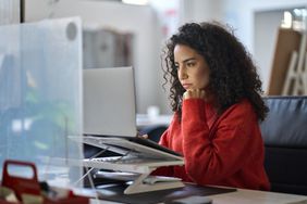 Woman sitting at a desk working on a laptop