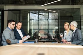 Young couple and their lawyers talking about the divorce during a meeting in the office. 