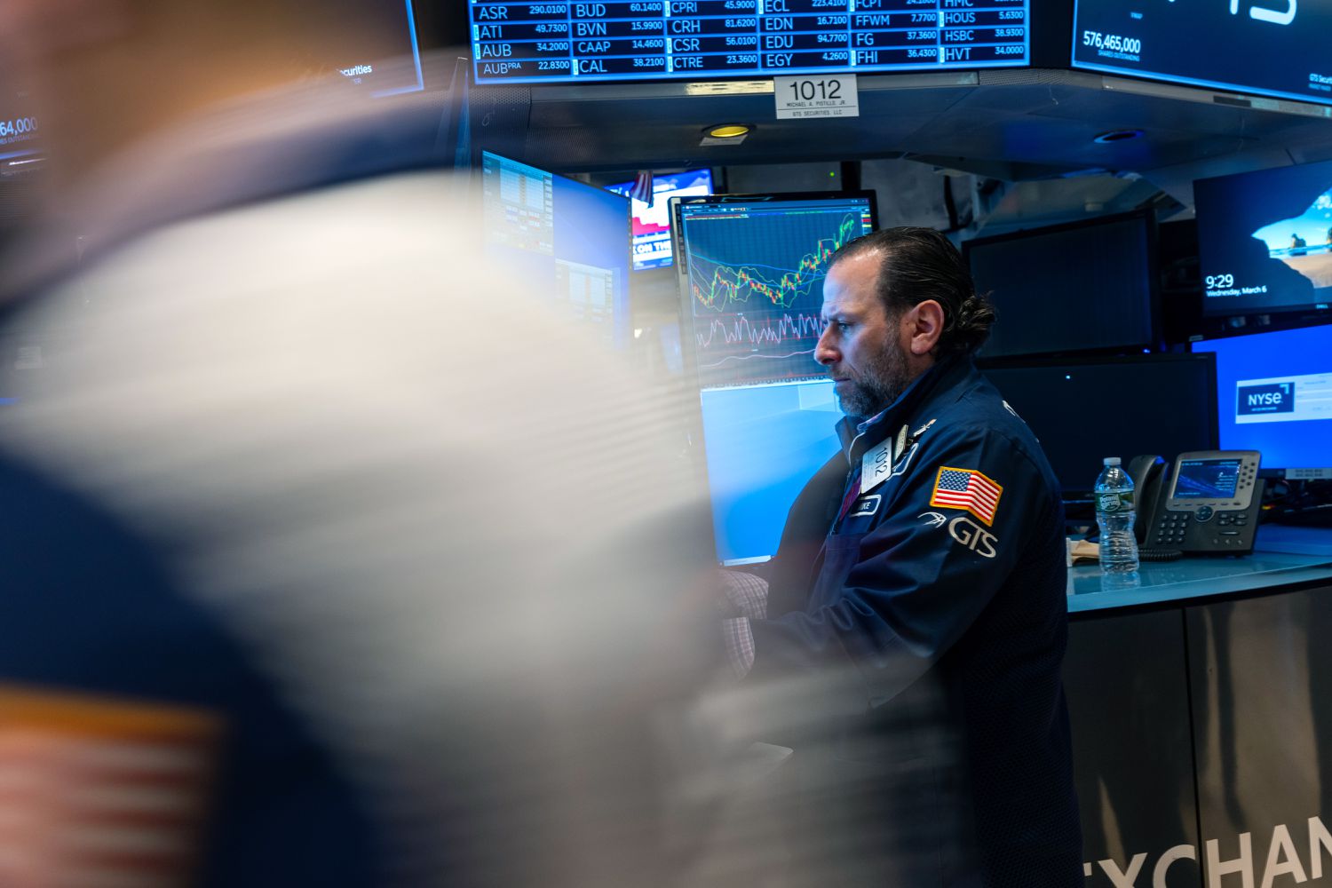 Traders work on the floor during morning trading at the New York Stock Exchange.