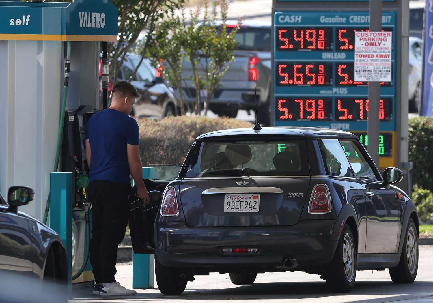 Consumer putting gas in car.