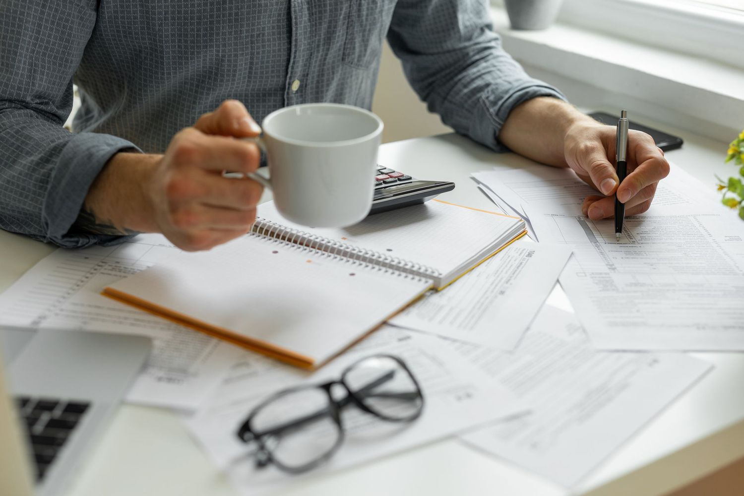 A person with papers at a desk