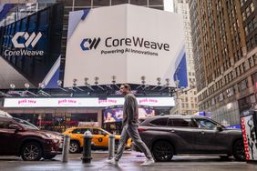 People and cars are seen below a CoreWeave billboard in Times Square.