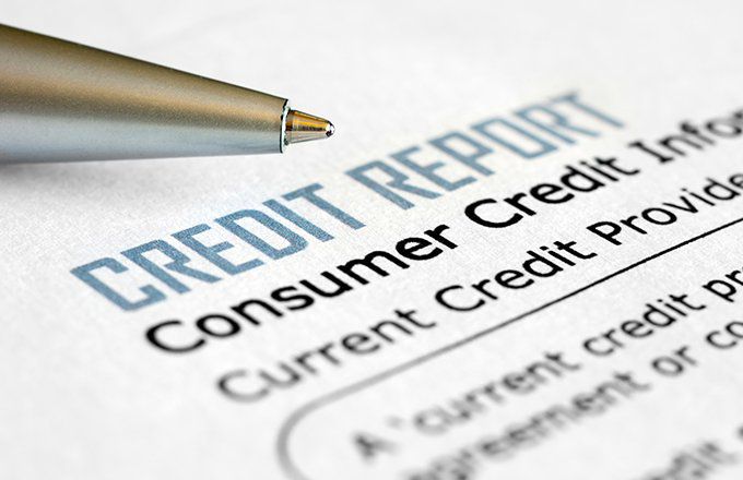 Closeup of a credit report form with a ballpoint pen.