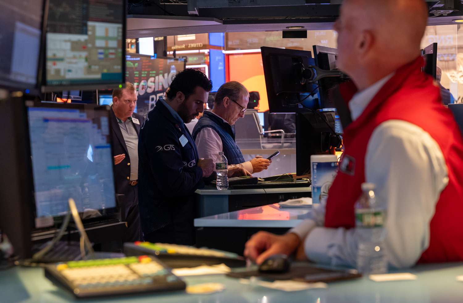 People walk on the floor of the New York Stock Exchange (NYSE).