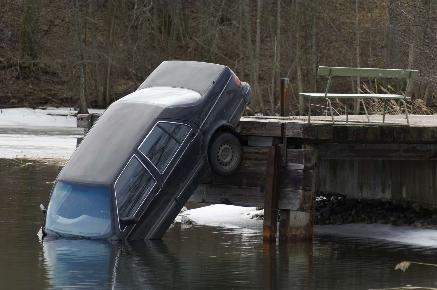 A car that's fallen into a lake, likely a total loss