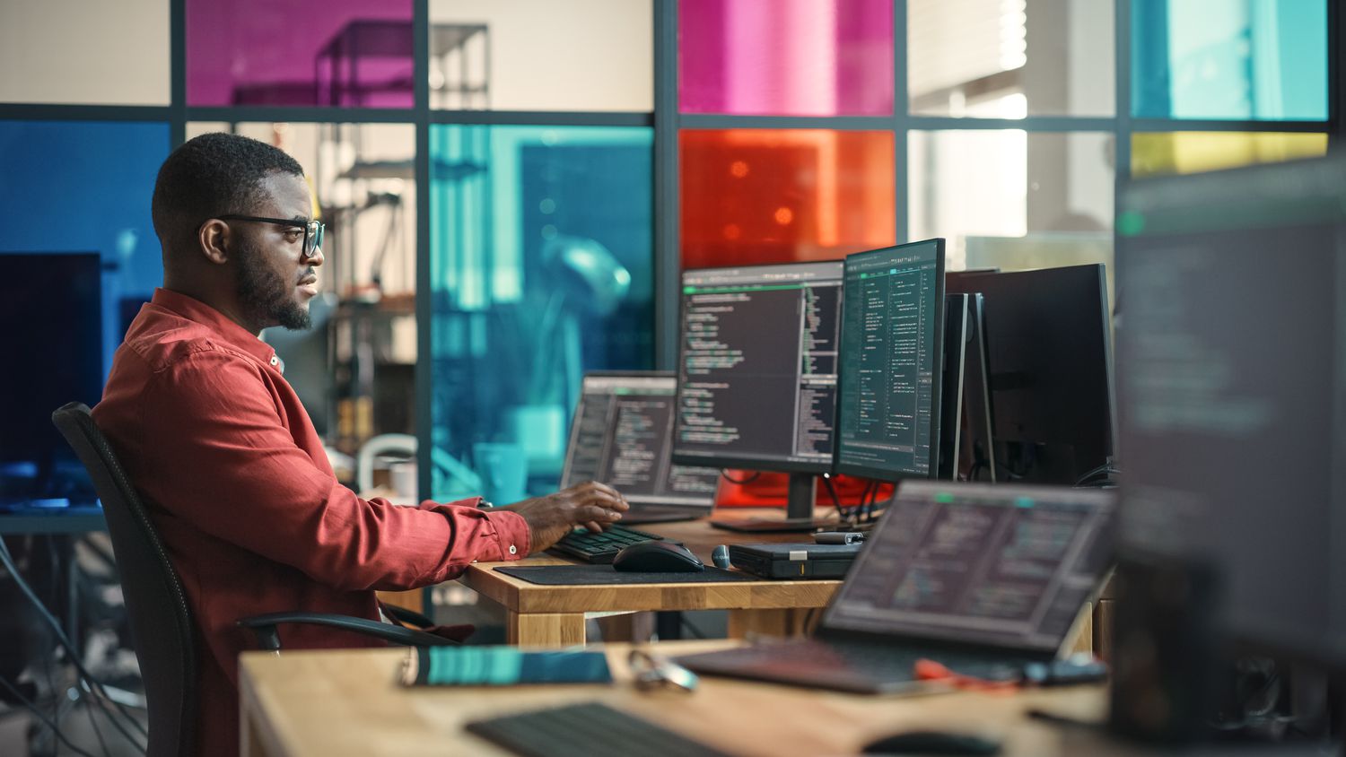 A man writing code on a computer