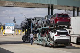 A car hauler truck gasses up before making its way to the Ambassador Bridge to cross into the United States at Detroit on April 1, 2025 in Windsor, Canada. 