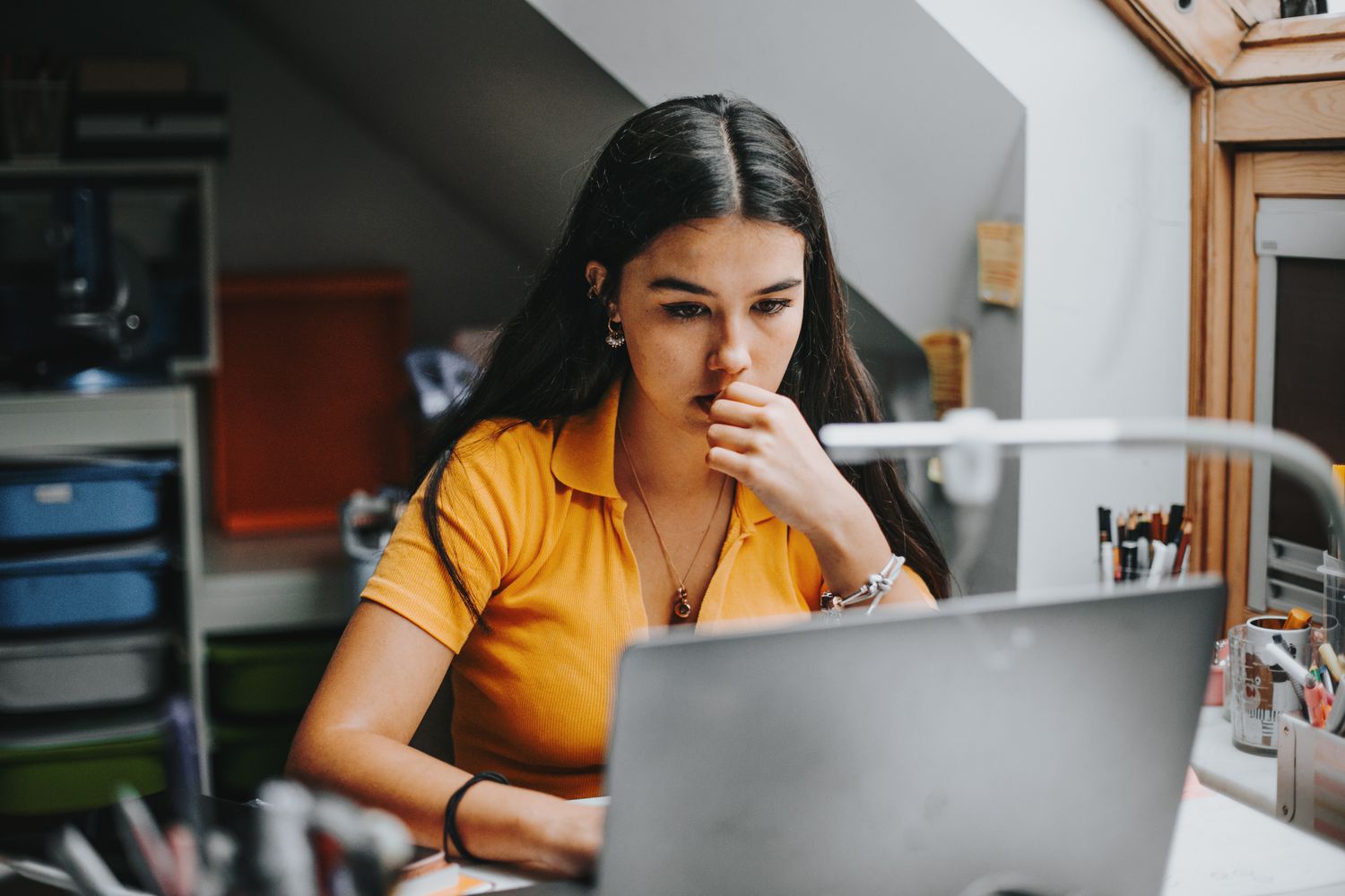 Young Hispanic woman studying laptop