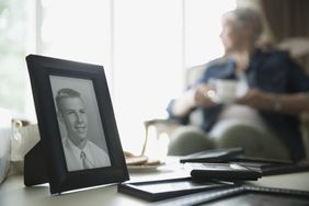 Old photograph of man with senior woman in background