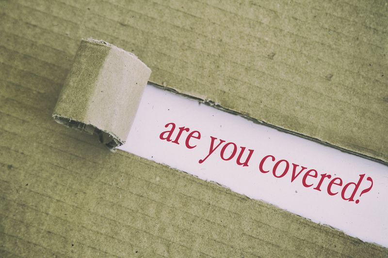 Cardboard peeled back over words "are you covered?"