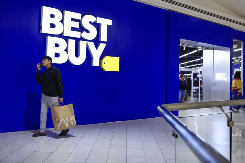 Shoppers walk by a Best Buy at a mall in New Jersey. 