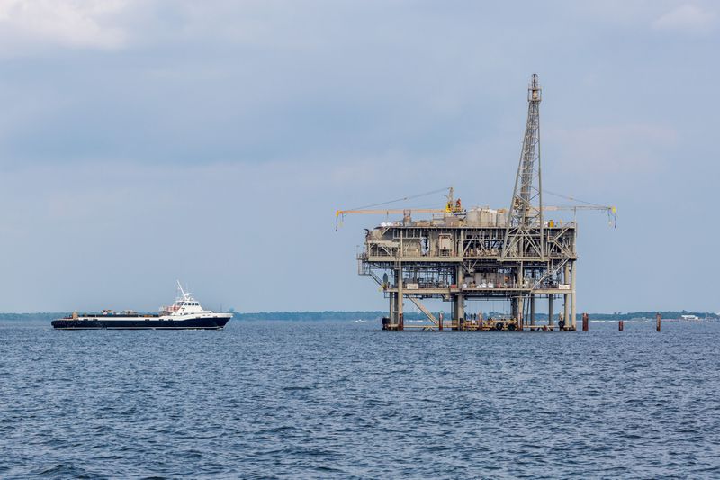 A ship approaches an Exxon Mobil oil rig in the Gulf of Mexico.