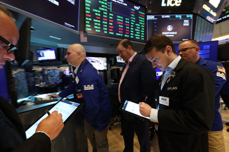 Traders work on the floor of the New York Stock Exchange (NYSE) at the opening bell on May 27, 2025, in New York City. 