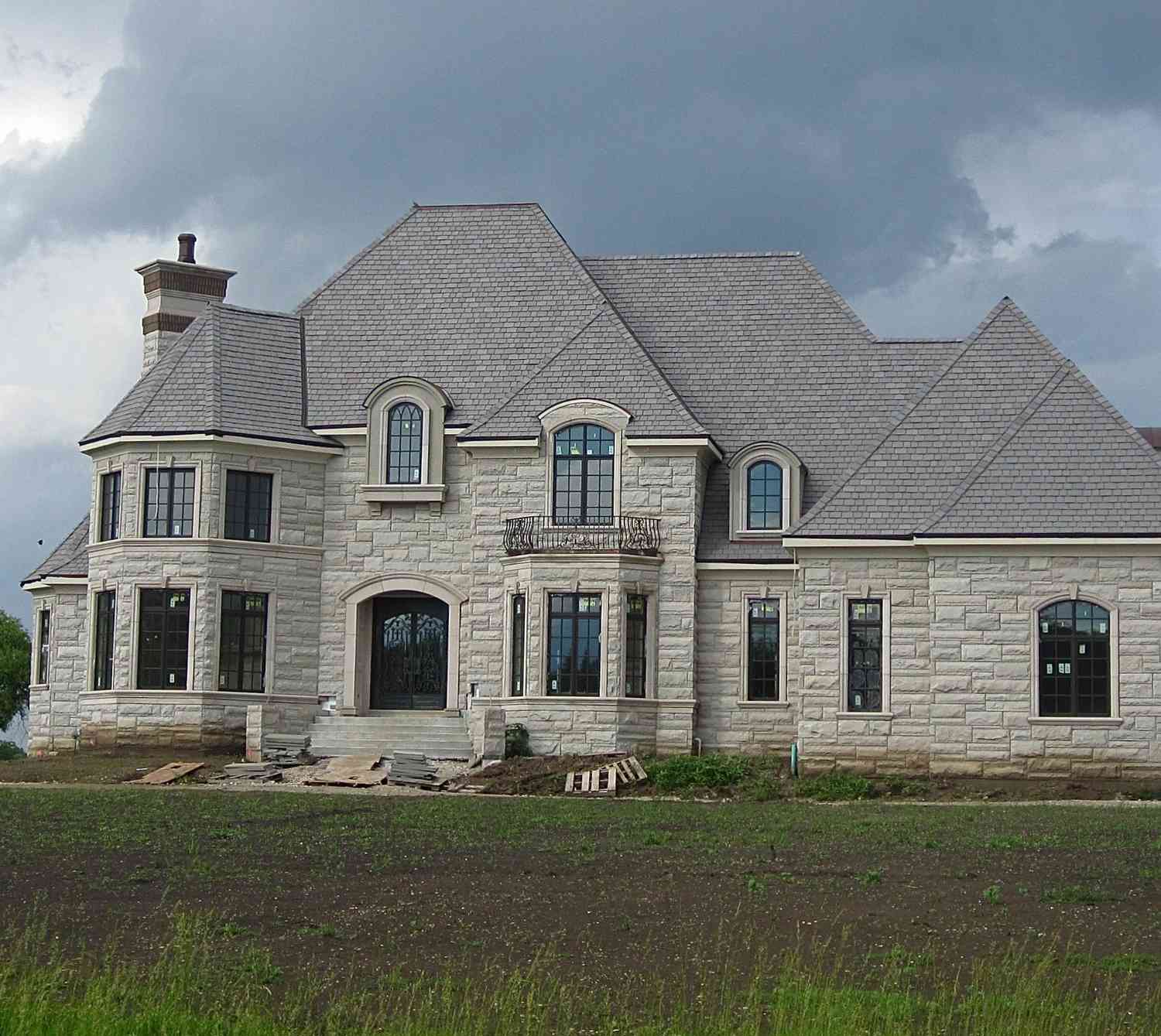Large grey stone mansion too big, so it's called a McMansion, in Illinois