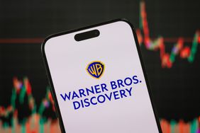 Warner Bros. Discovery logo is displayed on a smartphone screen