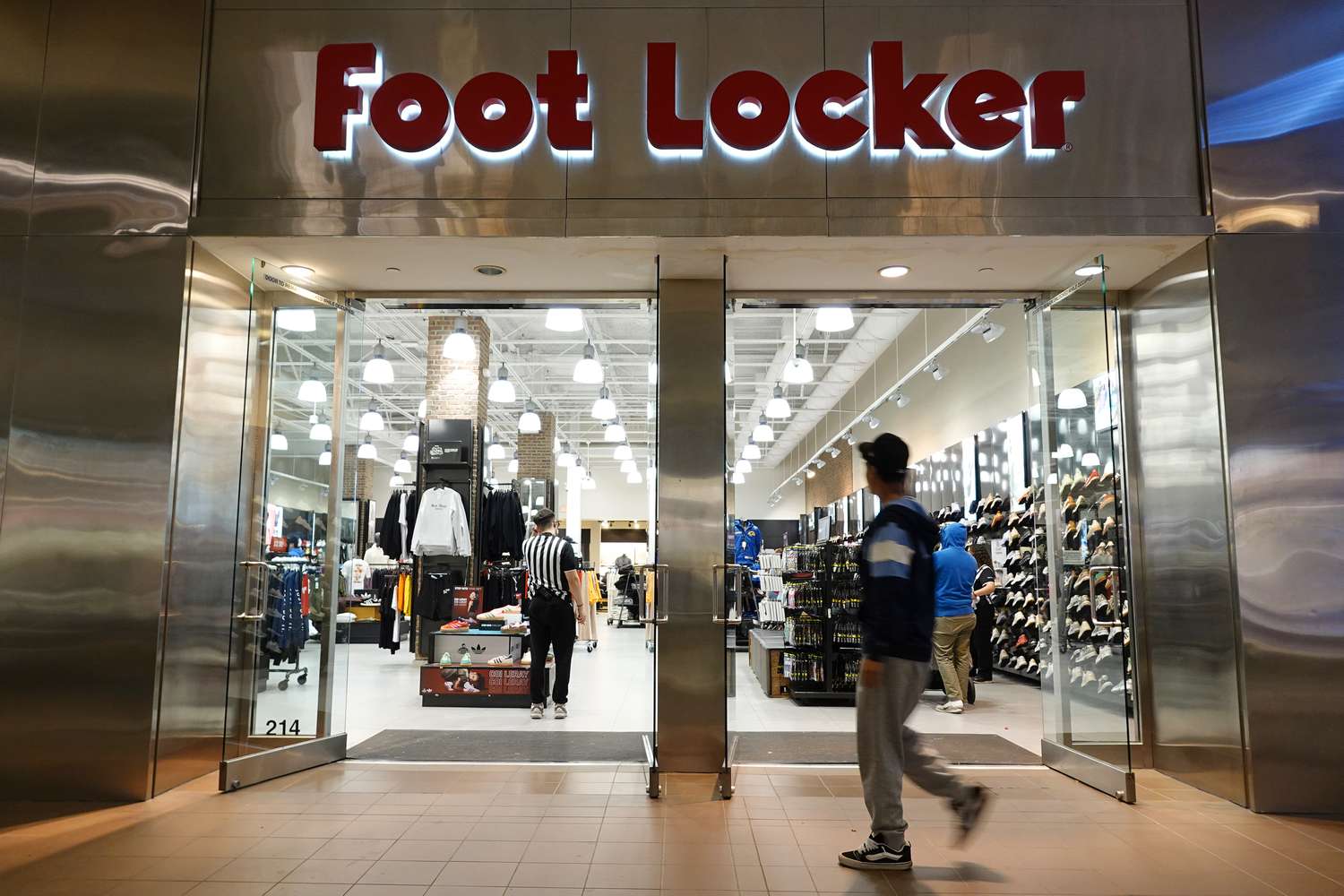 A shopper walks into a Foot Locker store at Fashion Valley, an upscale shopping mall on December 13, 2024 in San Diego, 