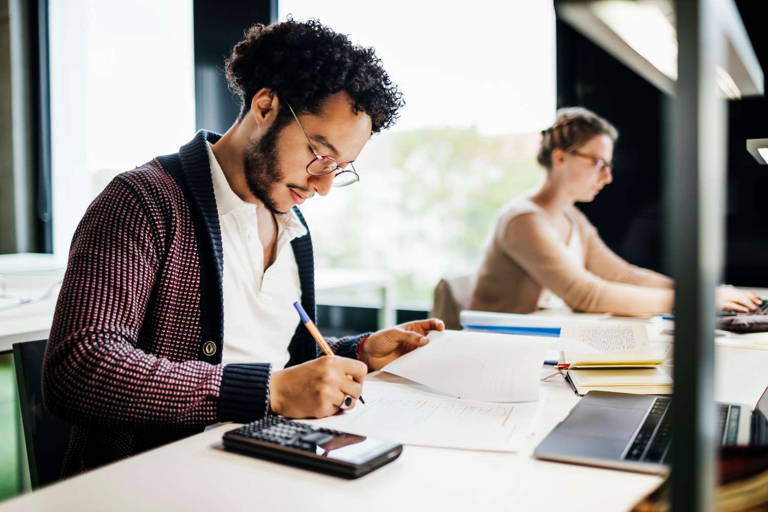 A man calculates which debts to prioritize for a debt avalanche