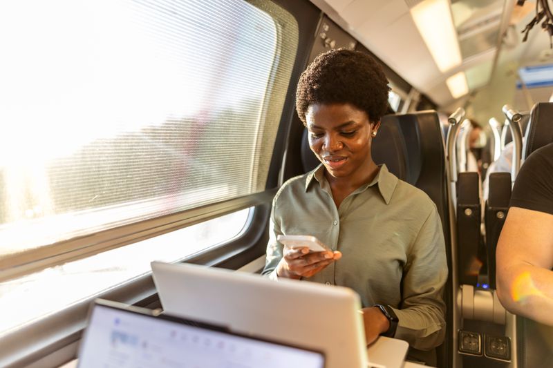 A woman on the train multi-tasking.