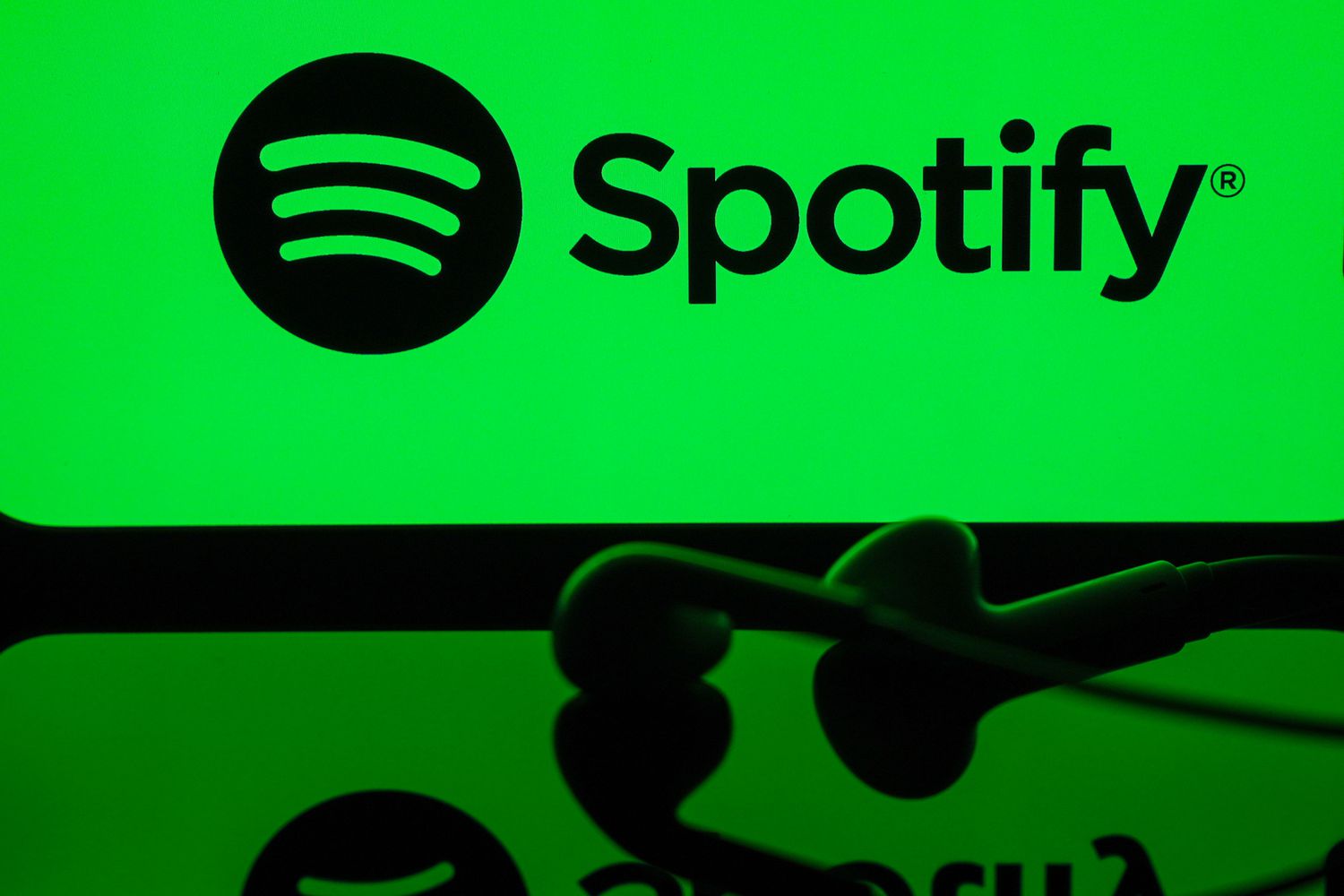 In this photo illustration a mobile phone screen displaying Spotify logo with a headset in front of it, in Ankara, Turkiye on May 01, 2024