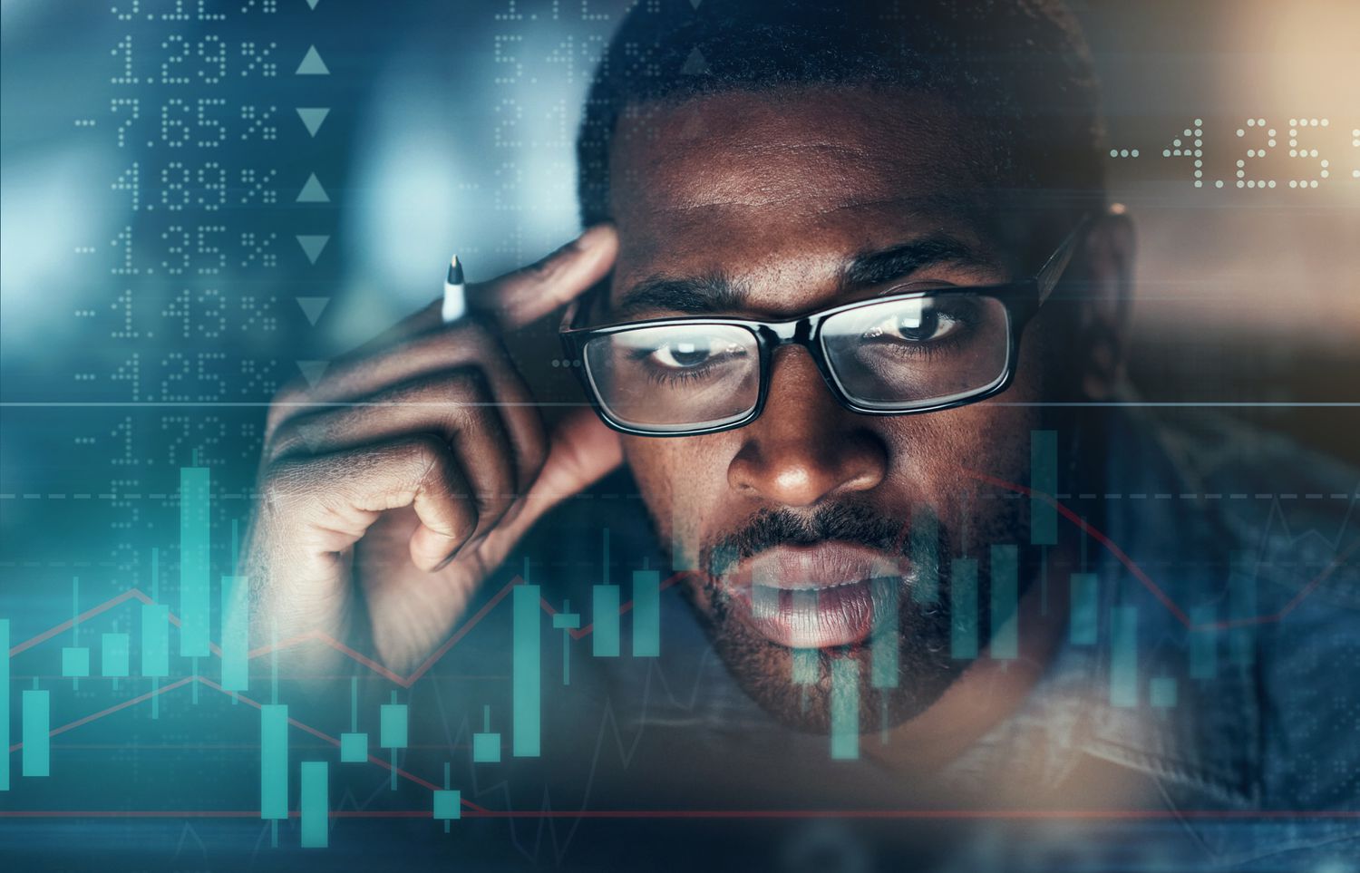 A person with glasses looking in at a screen of financial prices.