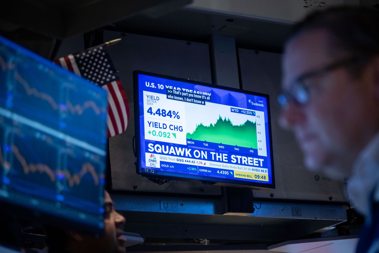 A TV broadcasts market news on the floor at the New York Stock Exchange.