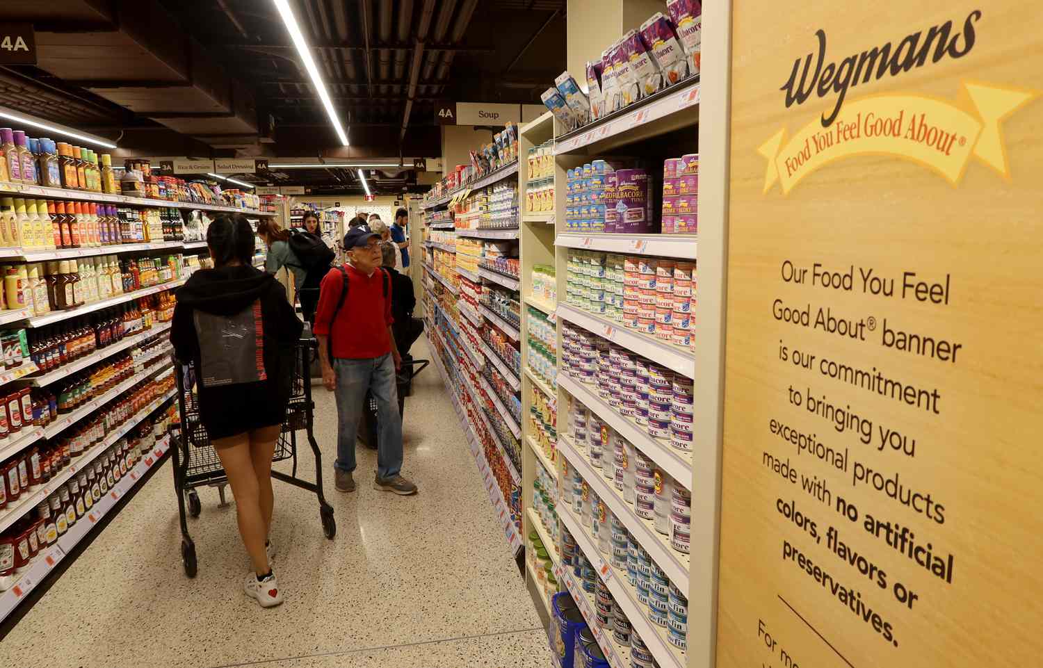 People shop at the new Wegmans Astor Place grocery store on Oct. 28, 2023, in New York City. 