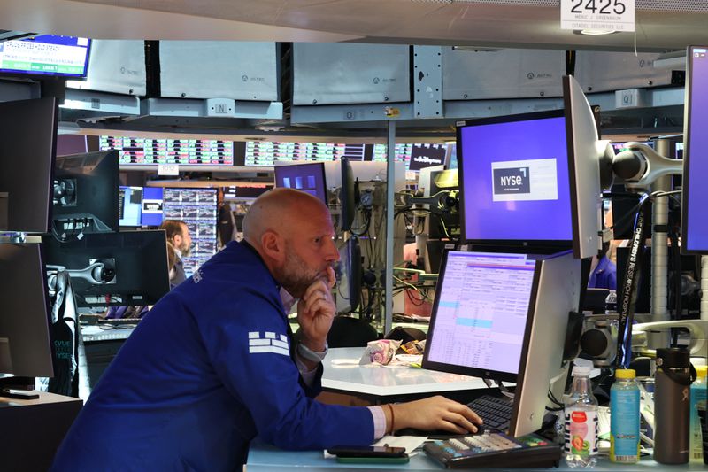 A trader works on the floor of the New York Stock Exchange (NYSE) at the opening bell in New York City, on May 27, 2025. 